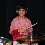Drums kid smiling headphones cropped 2